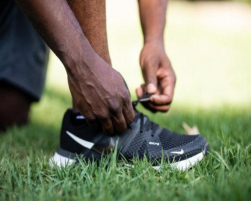 Fitness instructor tying running shoes